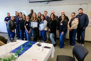 The Fresno USD Nutrition Services team displays a certificate achievement with partners and supporters